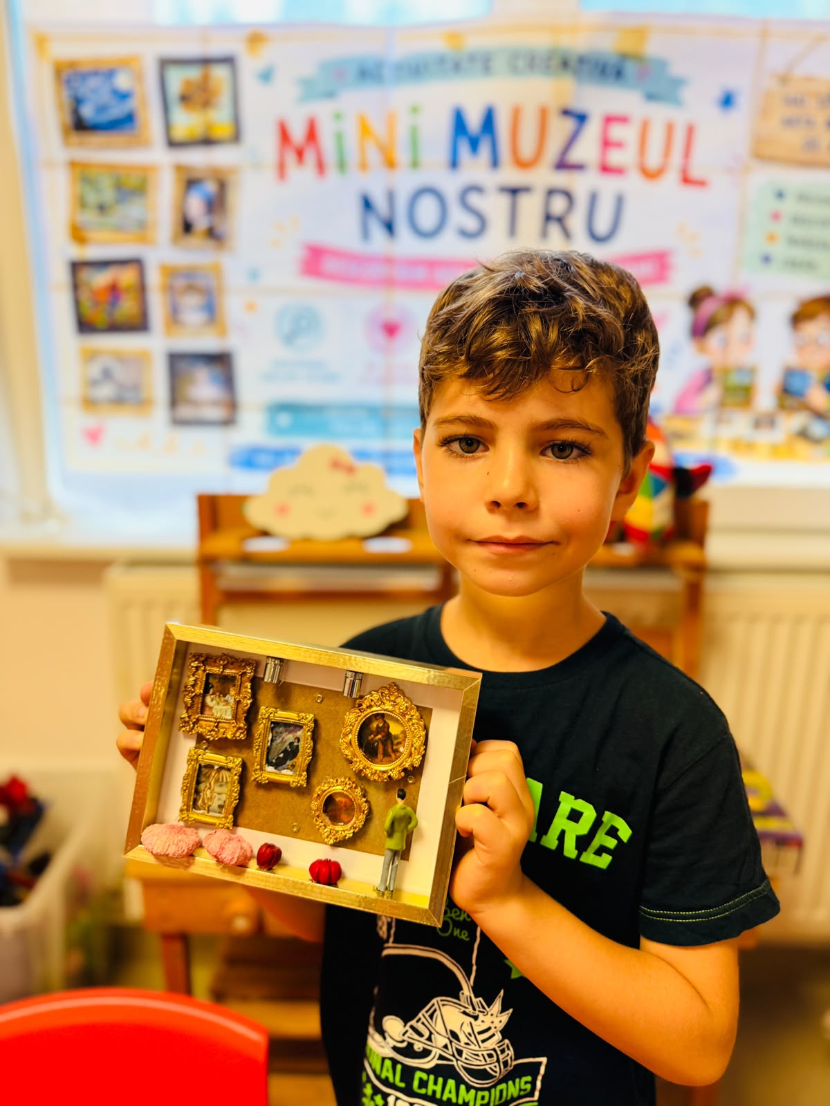 Băiat prezentând mini-muzeul realizat de el la atelierul creativ